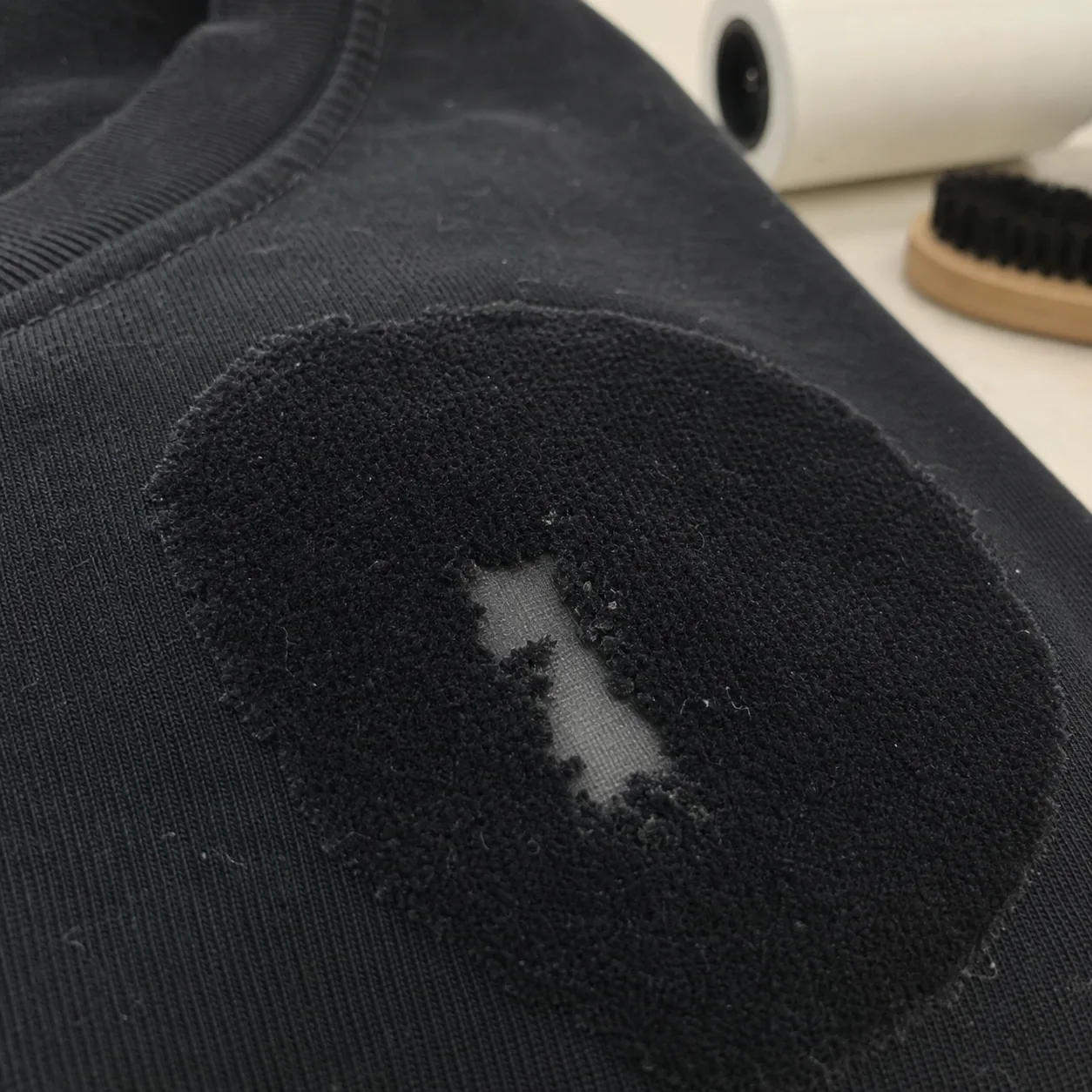 Flock fibre loss with adhesive remaining on the fabric