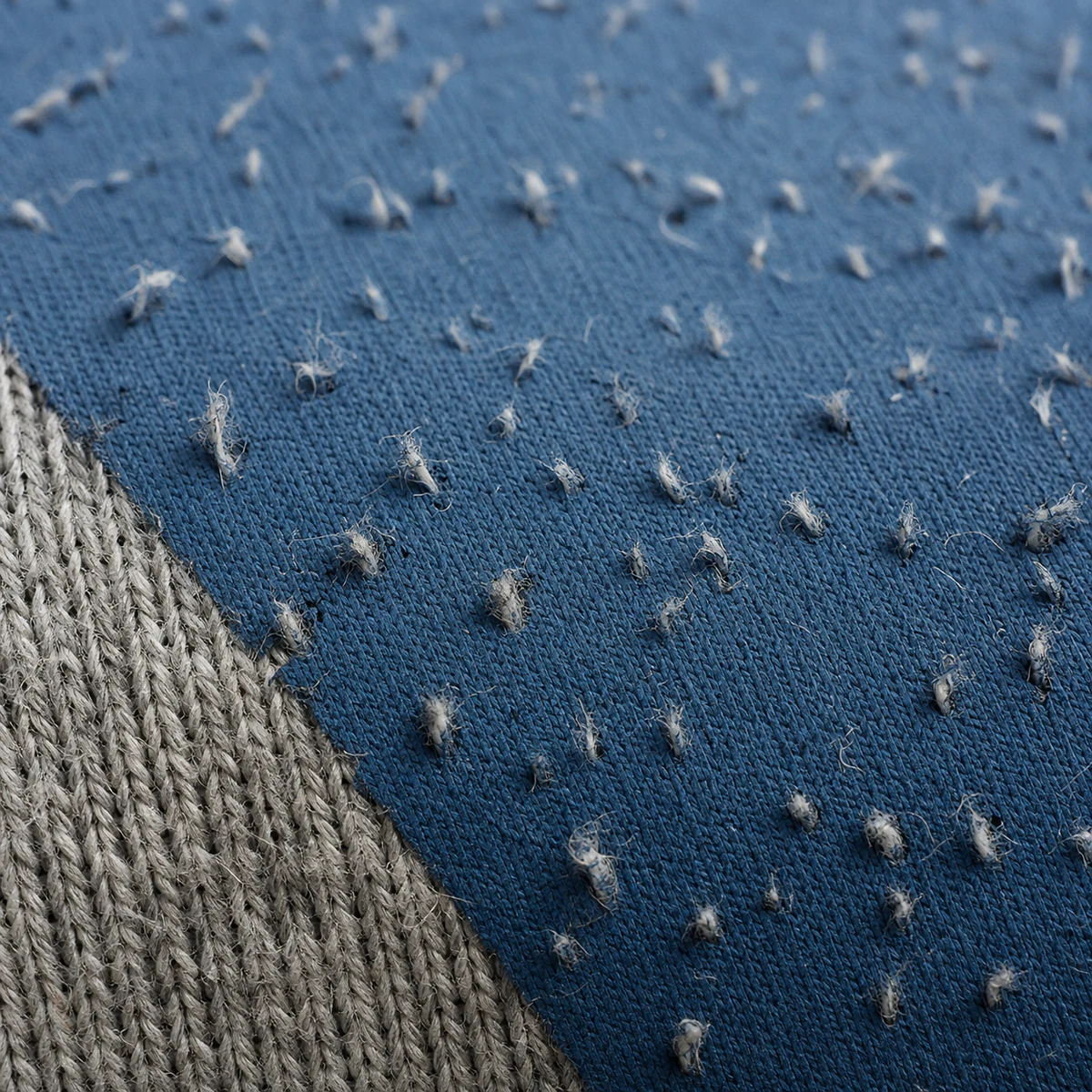 Cotton fibres showing through a screen print after washing