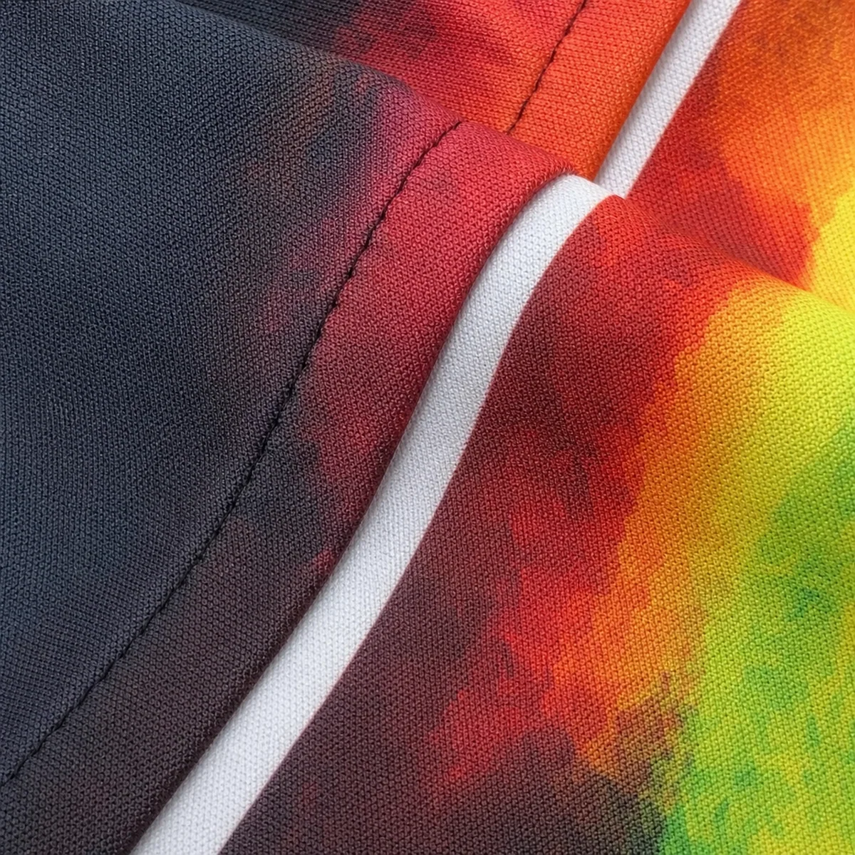 White sublimation crease beside a raised garment seam